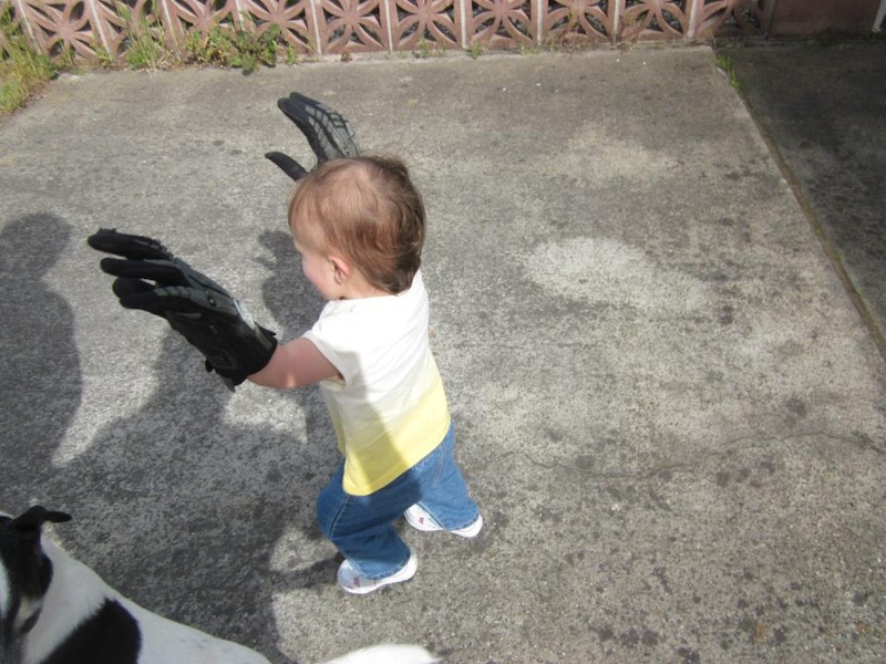 "Silly daddy....gloves are for kids." 

Little girl just can't get enough of my bikes and stuff, haha.