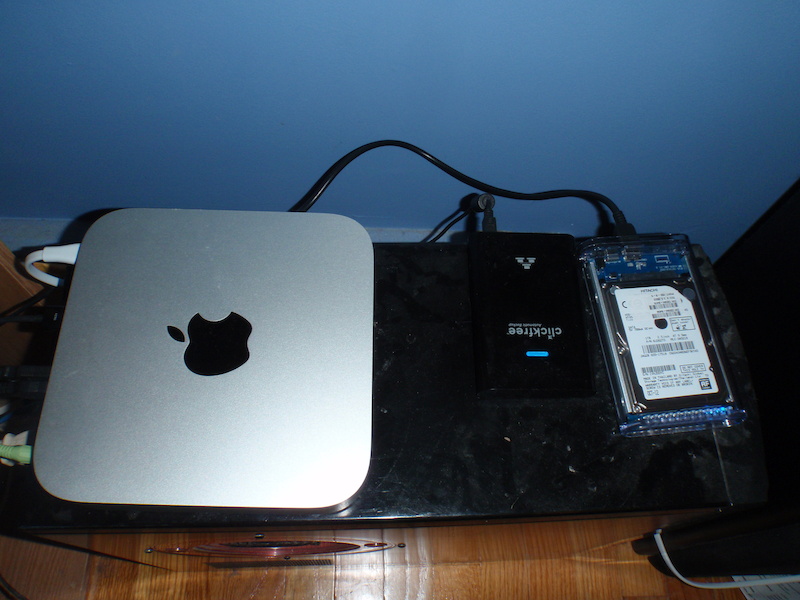 My new mac mini sitting onto of my old desktop along with the new external I created out of the minis old 1TB HD the clear one 