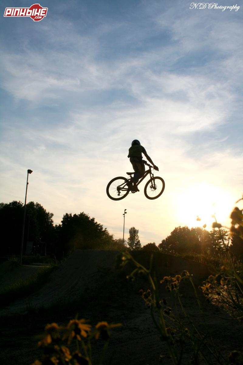 Cool picture of a friend I took during our road trip in Germany. We rode a sweet trail called " Dirt Park
Freiburg " with cool riders, sweet jumps and a nice weather. On this picture I like the flowers the sunset and the angle. This was our last ride in this trail. Was sweet, cool days.
