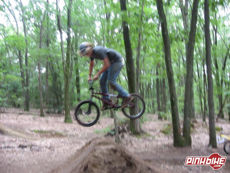 blurry photo of sam doing a 360 on a dirt spine...