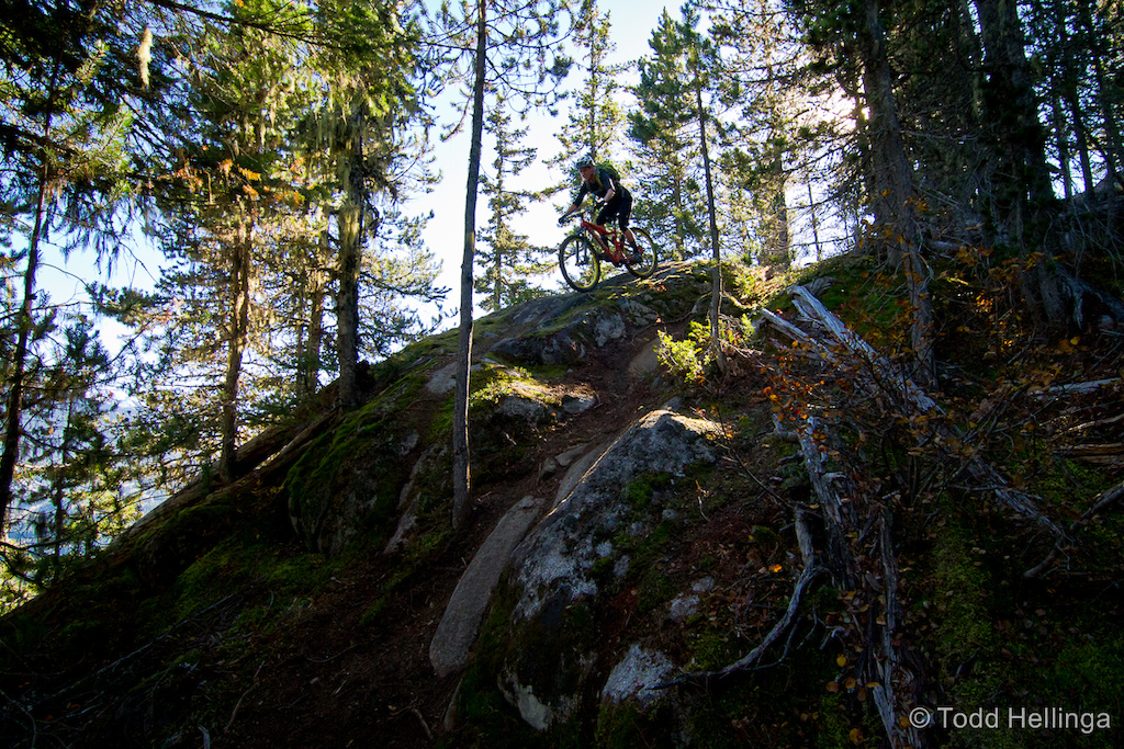 Dropping into a rock roll on Whistler's westside trails
