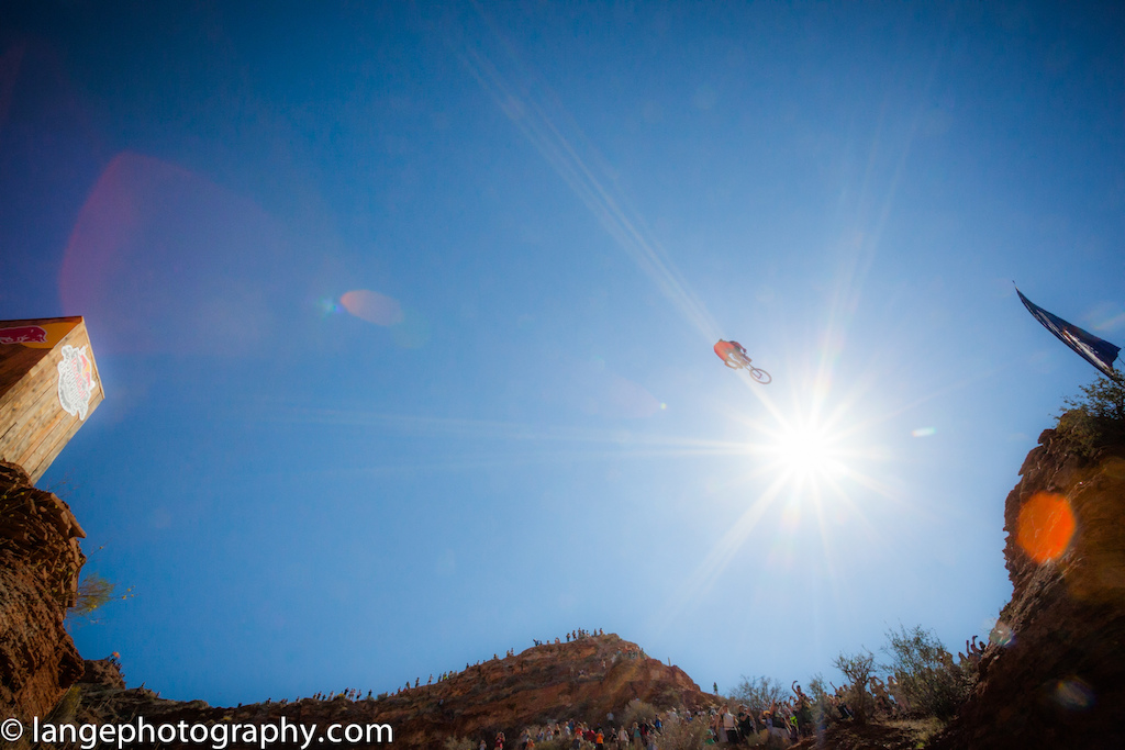 unidentified rider (any leads?) over the canyon gap and into the sun at redbull rampage 2013, virgin, utah.
