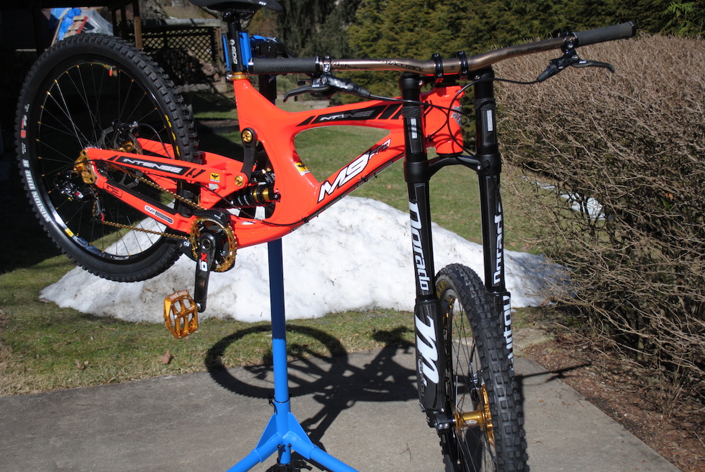 2013 Limited Edition M9 FRO (Flo orange, gold bling kit, and carbon upper link). Dorado Expert, CCDB, Full Avid XO drivetrain, XO Trail brakes, RaceFace Atlas bars, Hope pedals, Hope 36T chainring, Hope post clamp, Hope Evo Pro II hubs, Mavic EX721 rims, Maxxis DHF ST Front and DHR II 3C Rear.