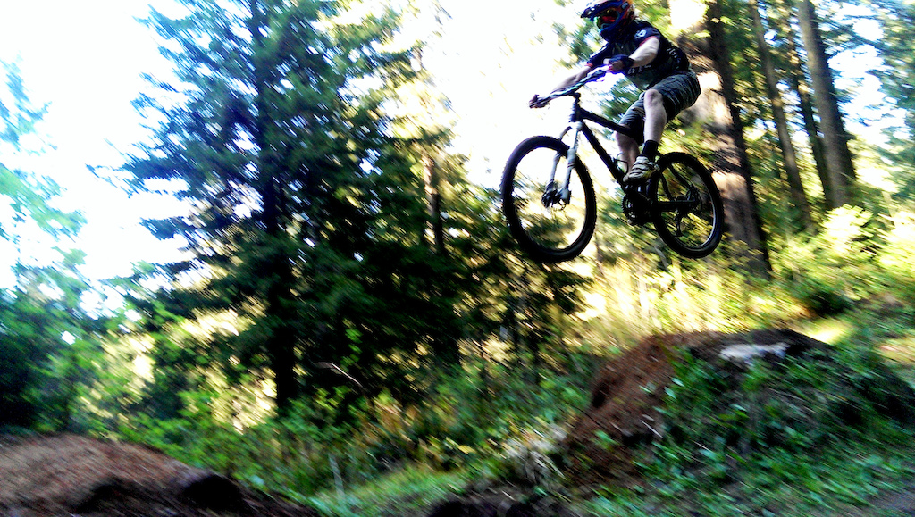 Hitting some jumps on the way down the hill and scored this photo.  Notice the hard tail.  It's all about the rider! Not the bike!