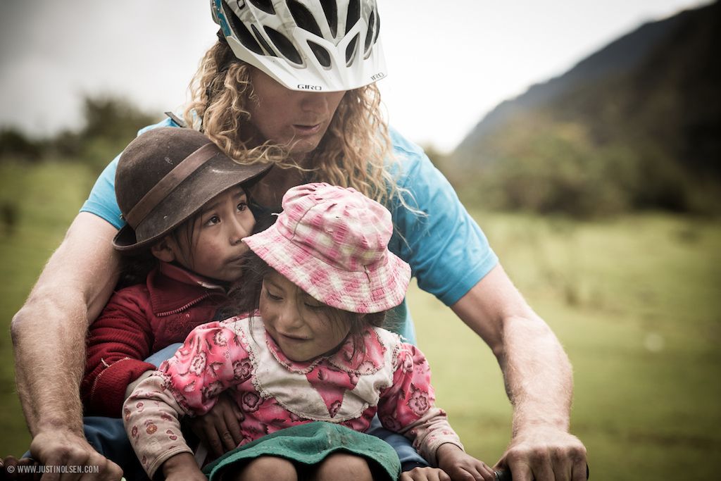 Kelly McGarry, the gentle giant, taking a moment to share the joy of 2 wheels with some Peruvian children.