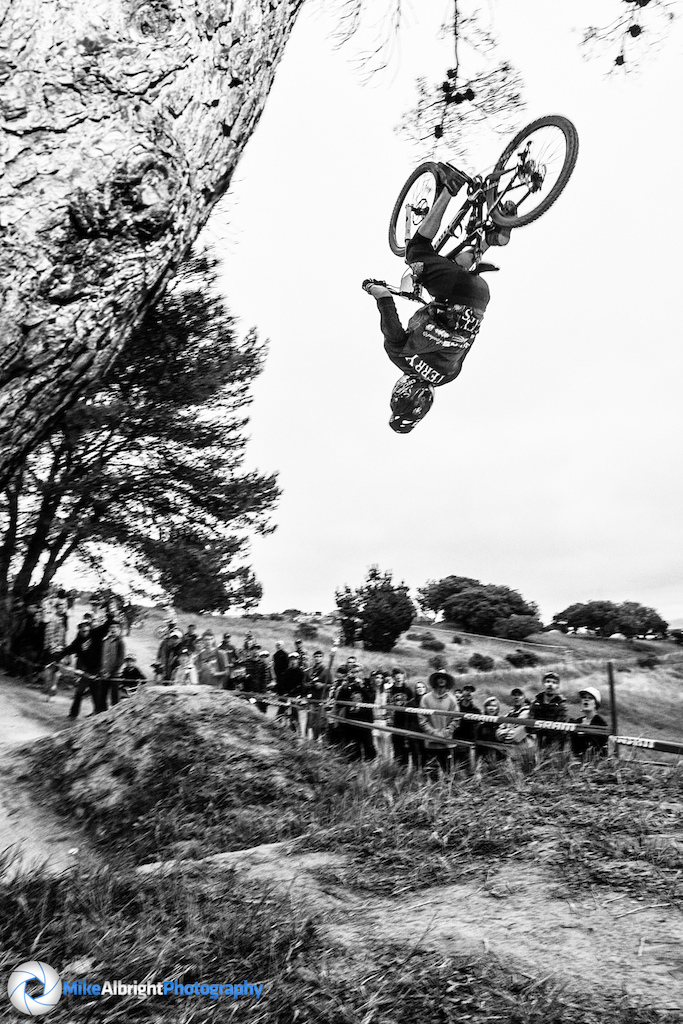 Andrew Terry backflips the kicker jump at the 2014 Sea Otter Classic Downhill race.