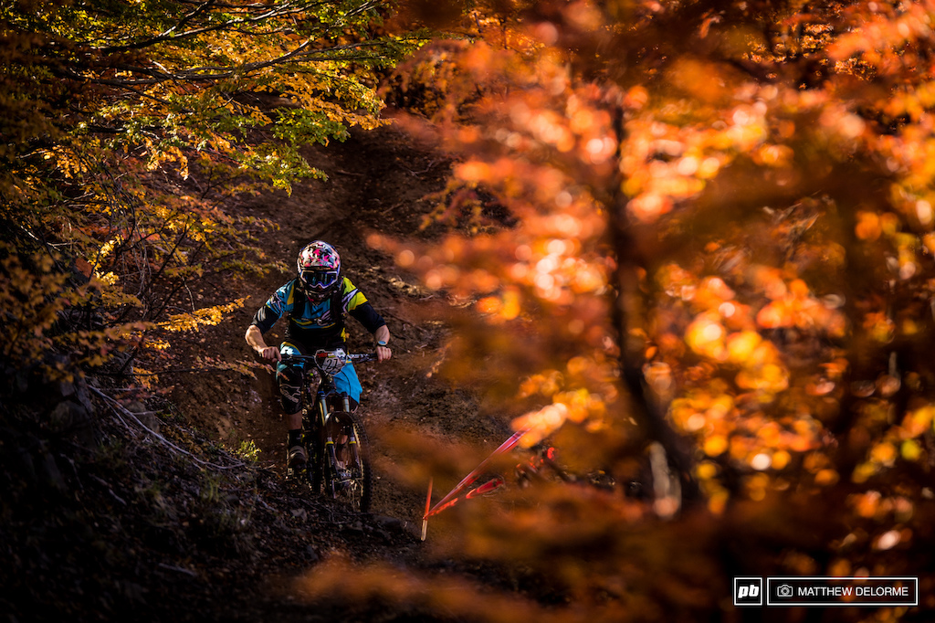Manuel Ducci through a tunnel of reds oranges and greens on Stage 2. Nevados de Chillan has such a variance of terrain from insanely steep chutes to high-speed open rock and sand there is a little of everything to test every skill set.
