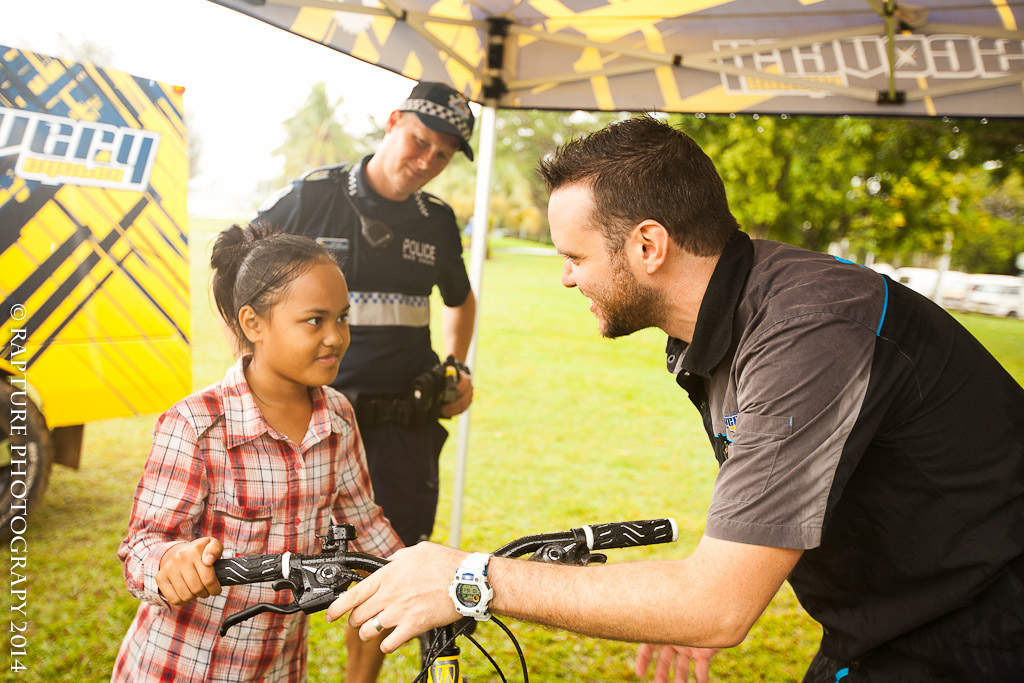Larry from Discovery Cycles guiding this young girl through how to use the gears on her new bike.
