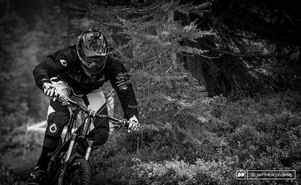Dan Atherton smashing through the shrubbery keeping his line high and tight. Atherton is looking comfortable on the bike and carrying good speed.