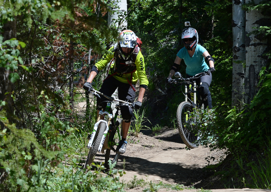 Nicole Miller follows Steamboat Bike Park instructor Andrew Burnsâ tips as she navigates turns on the Wrangler Gulch trail.