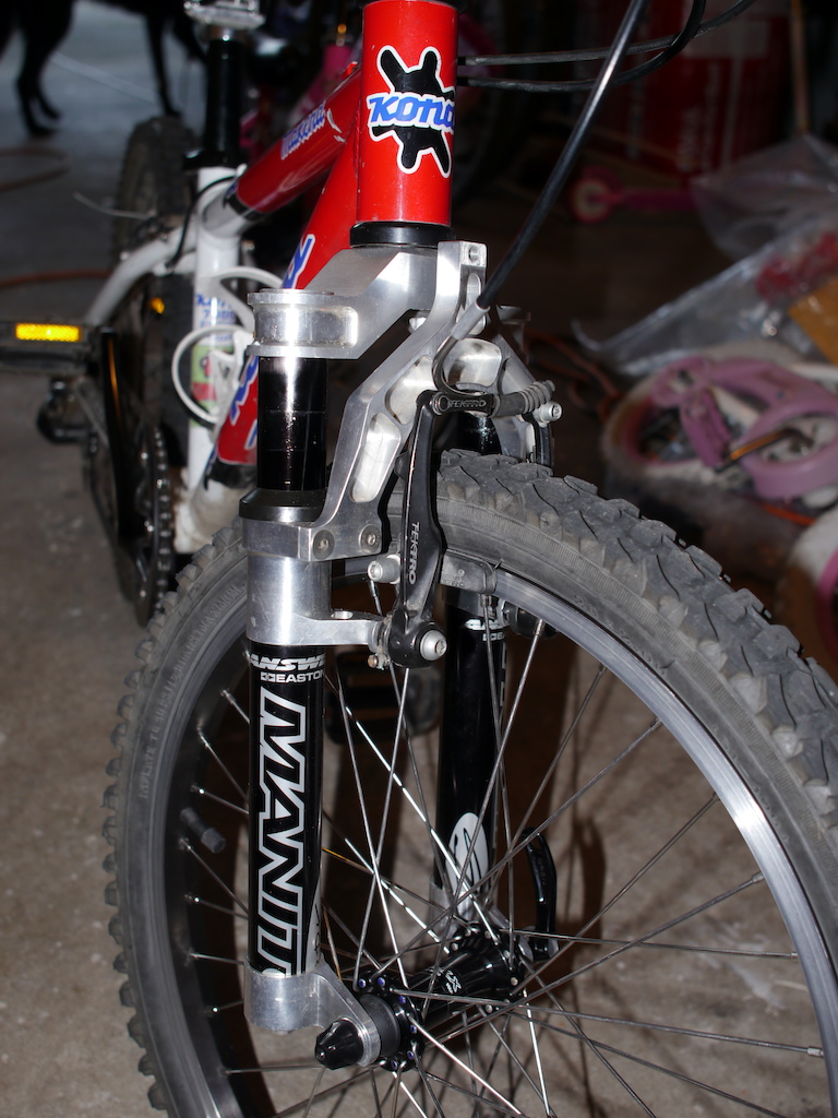 Shortened Manitou Sport Fork (1995)
Only 1100 grams!  WAY better than the stock Suntour fork at 1850 grams.  Plus now it actually moves under my sons 55 to 60lb weight.

Other mods to the bike brought the total weight of the bike down to 22 lbs.  It started at 26.5 which is too heavy for a kid especially since we ride trails (with hills).  A lighter rear tire and a better rear hub are all I would do to make it lighter.
