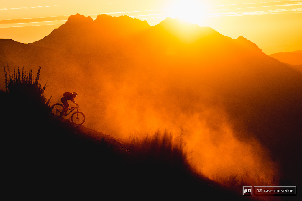 Anka Martin takes the final shot of the day, riding through the dust as the sun sets behind the Andes Mountains in Chillan, Chile.