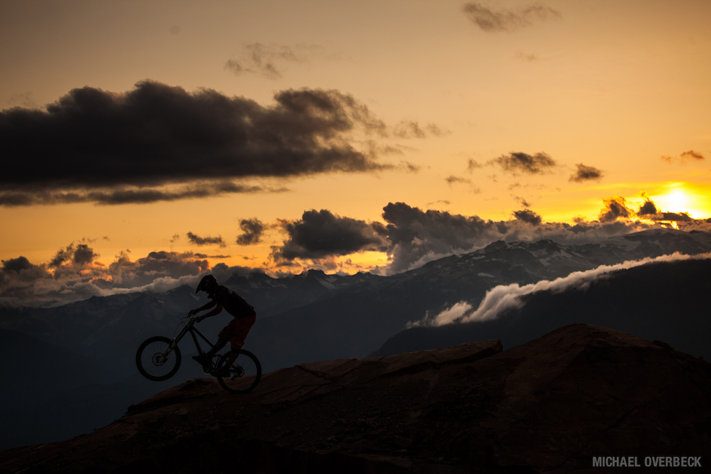 Malcolm pulling off a manual on a sharp ridge, at sunset this past summer.