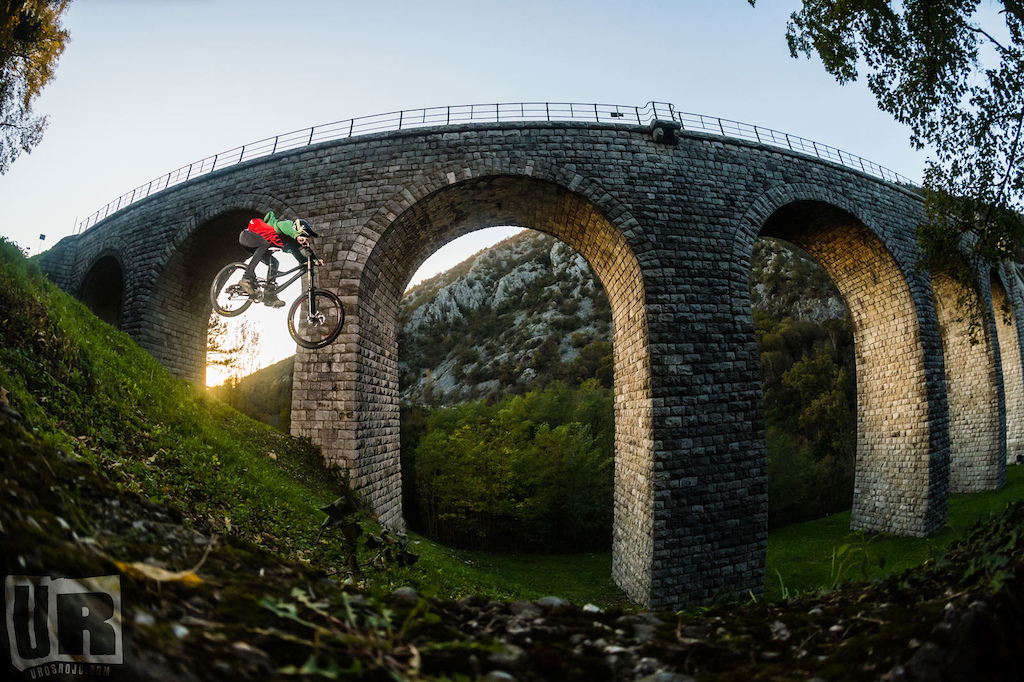 This photo was taken in front of the longest stone arch bridge in the world. This is actually a monument that is in use by the railway. One day that I brought some visitors from Poland to see the bridge, I noticed that the spot is not just super photogenic but its also usable for a gap photo.
On the same night I meet Niki on a party, showed him a couple of photos from the spot I made with my phone and he loved the scenery. In couple of weeks time we did this shot. It was super fast shoot we had only 20 minutes of the perfect sun light on our disposal. Luckily Niki nailed it every time :) 

Enjoy