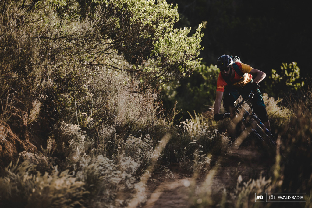 Daniel attacking the flowing singletrack with the last rays chasing him.