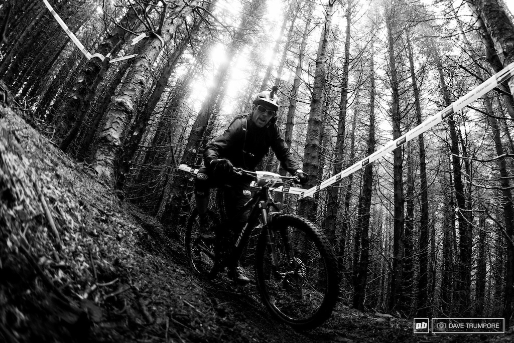 Francois Bailly-Maitre rolling the big wheels through the tight trees
