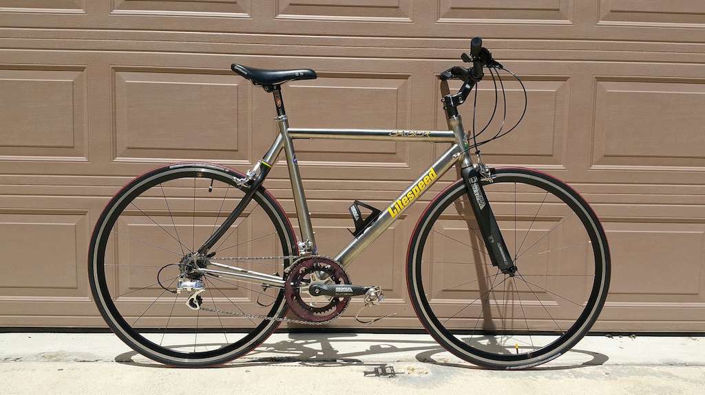 My dad's bike. He's not comfortable riding with drop bars anymore; needs to be in an upright position. We customized this carbon/titanium litespeed so he'd have something fast, light and comfortable to ride. Really nice bike for him. It weighs in at 18.5 lbs as it is in the pic.