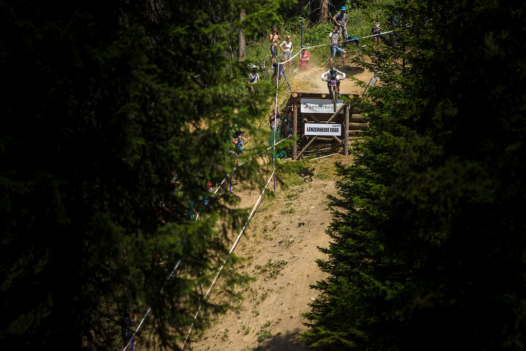 Manon plunges between the trees and keeps it rubber side down.