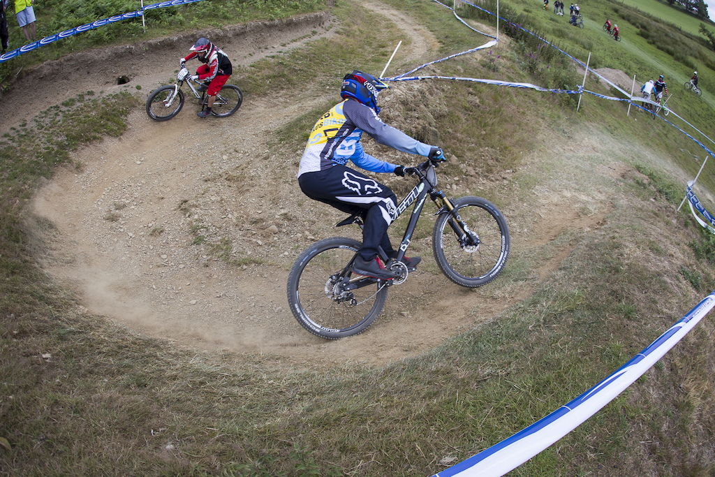 BDS organiser Si Paton follows Leisure Lakes Bikes Dave Richardson into the hairpin to get up to speed during The Schwalbe British 4X National Championship at Moelfre Hall Moelfre United Kingdom. 11July 2015 Photo Charles Robertson