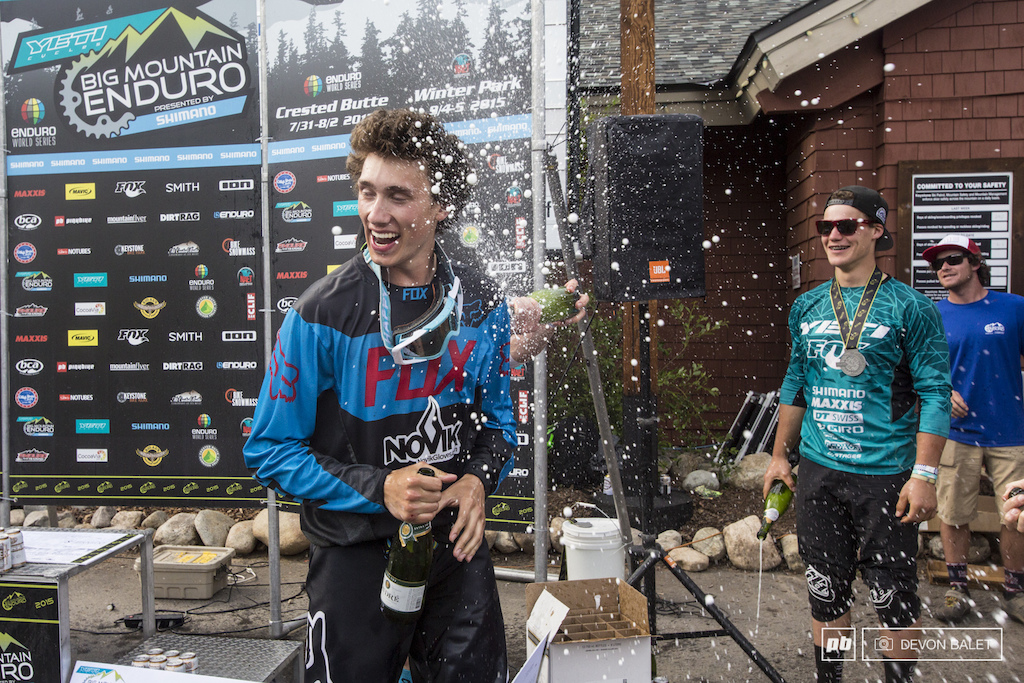 Austin Hackett-Klaube earning his way into the podium celebration as Jared and Richie unload their champagne on him.