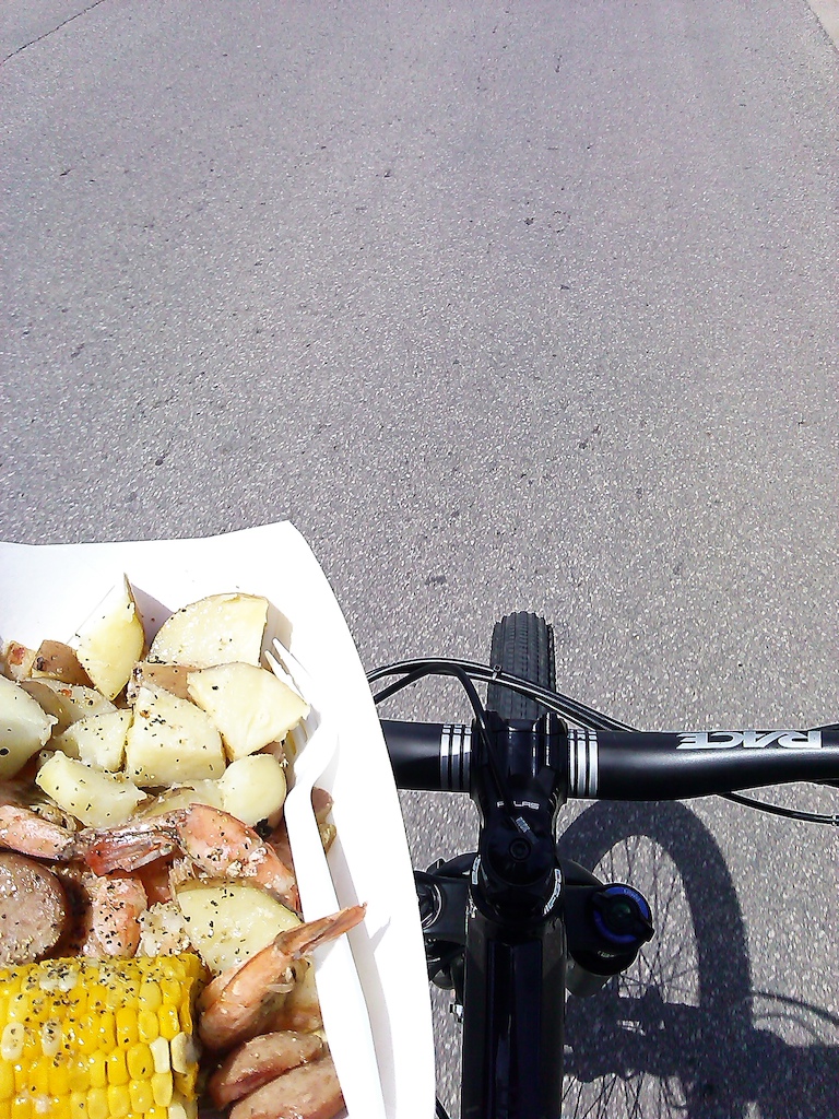 Texting and driving is hard when you're carrying shrimp boil on the bike.
