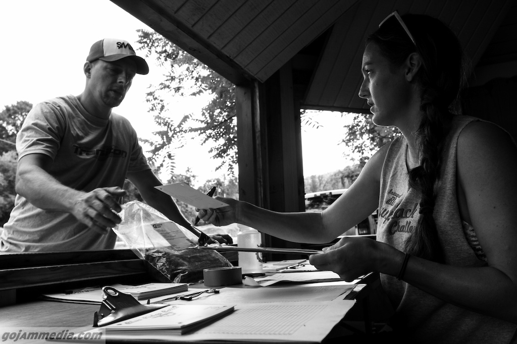Where Do I Sign? - Becky Bashton, doing double duty with both registration and racing, telling Cecil Linder how it is on a humid Weaverville, NC morning. Cecil brought the kids with him this weekend, so he had 3X the paperwork and 3X the $ to dish out.