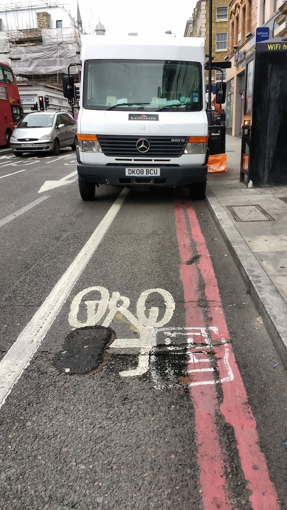 Its a cycle lane - you know a permanent one with a solid, thick white line. Its also part of the Red Route which means no stopping at any time...but this Loomis security vehicle is regularly stopped causing cyclists to endanger themselves by swerving into the road.
