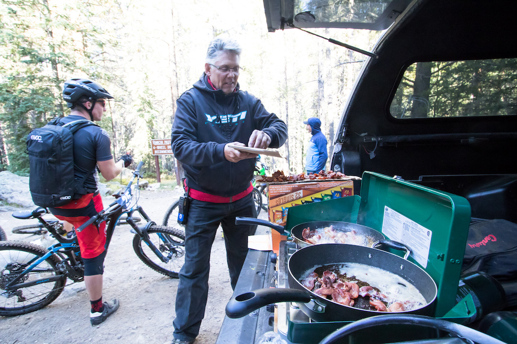 Race curator Keith Darner styles everyone out with some much needed bacon during the long transfer stage.