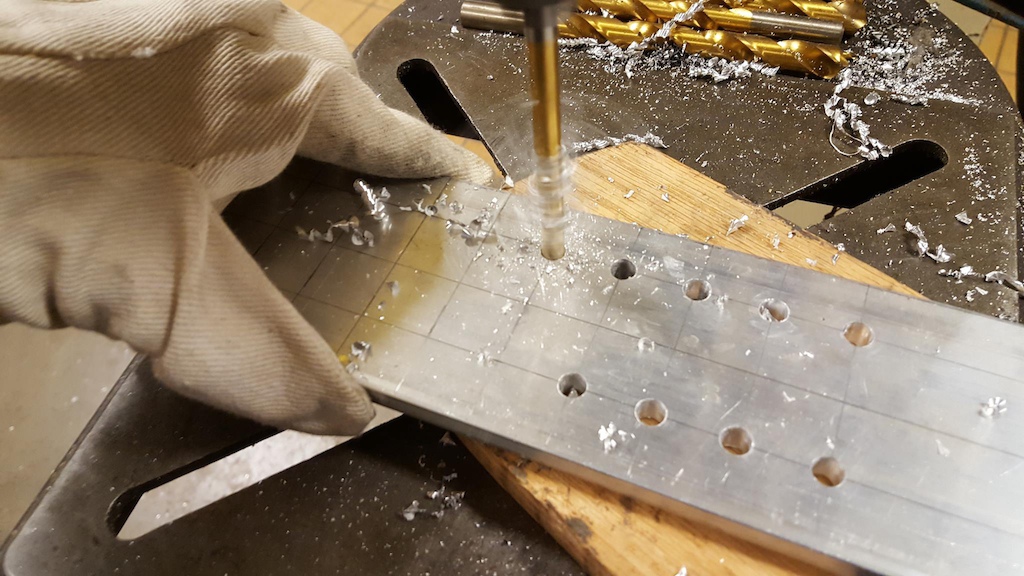 drilling holes in base plate to make ski's adjustabe