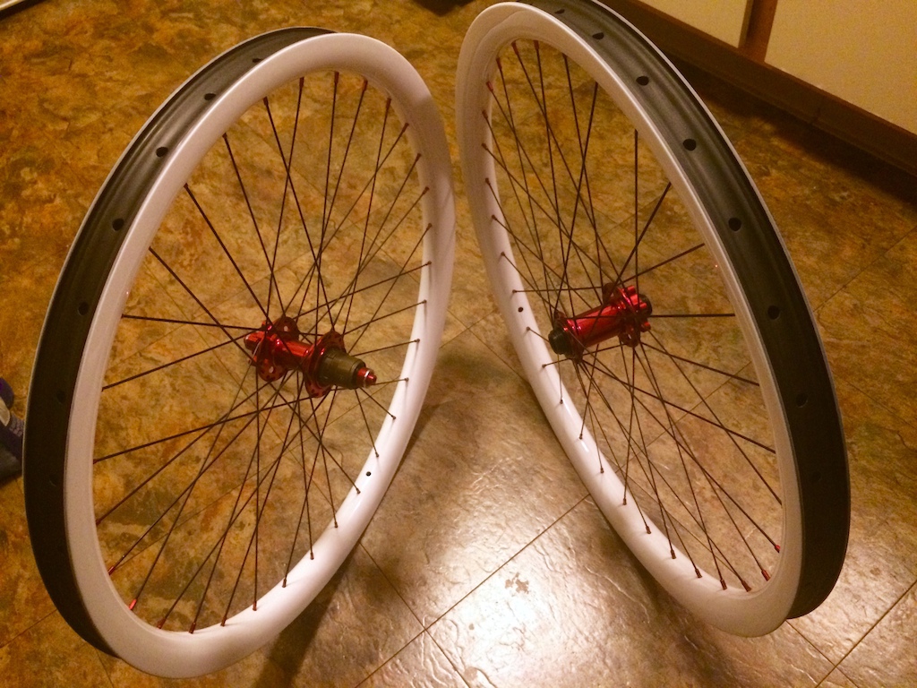 l-b 27.5 AM 38/32i wheelset, custom gloss white paint, no decals, red alloy nipples, black aero spokes, red BHS 32h hubs; 15/20mm front, XD rear