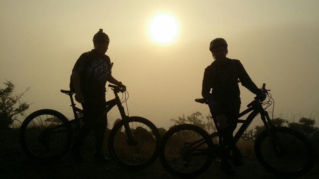 This was a early morning ride in January on south mountain in Phx Az.  Charlie and Bryan were taking a break on national on top of south mountain. The sun was just rising through the early morning fog.
