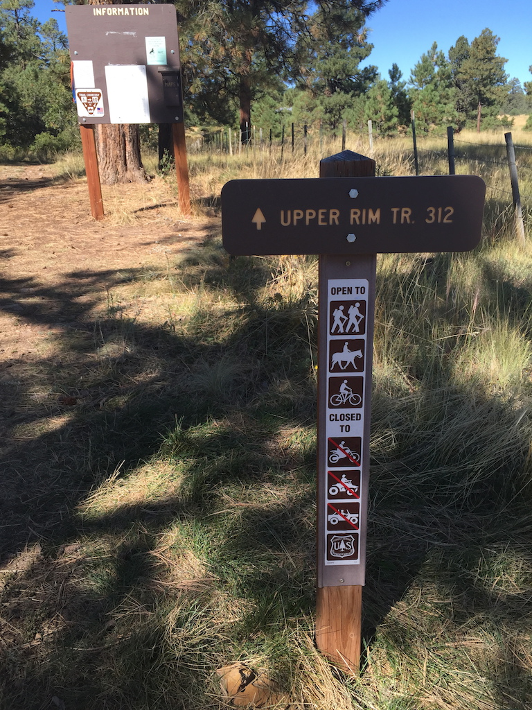 Trailhead sign and information kiosk with map.