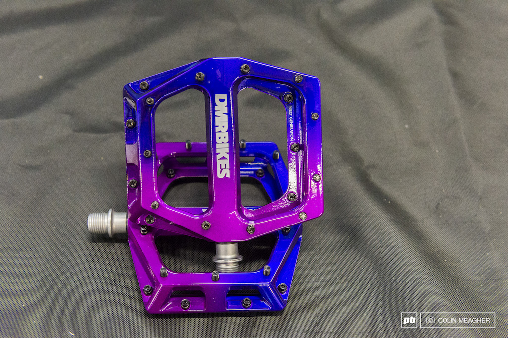 DMR Vault pedals. I can t say I persoanlly like this colorway specifically designed to match a Salsa fat bike that was unfortunately not on display but I can t help but admire the look and feel of this 169.99 purple fade pedal. The 105 x 115 mm platform offers a generous secure grippy support underfoot. It features 11 pins and a 17mm concave footbed. It s constructed of 6061 aluminum that sits on a chro mo steel axle with high load DU bushing and a cartridge bearing to keep them spinning. 410 grams. DMR has less expensive and less eye searing versions of this pedal available at 147.