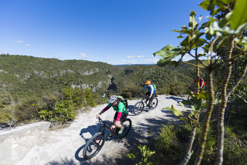 Kiri Brunton rides past the spectacular Tieke Falls during a journey on the Waihaha to Waihora section of the Great Lake Trail, Taupo, New Zealand.