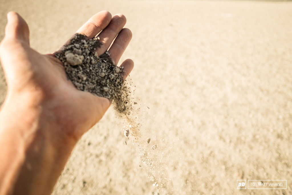 The volcanic sand is unreal, hard-packed on the ground, then it falls between your fingers like dust.