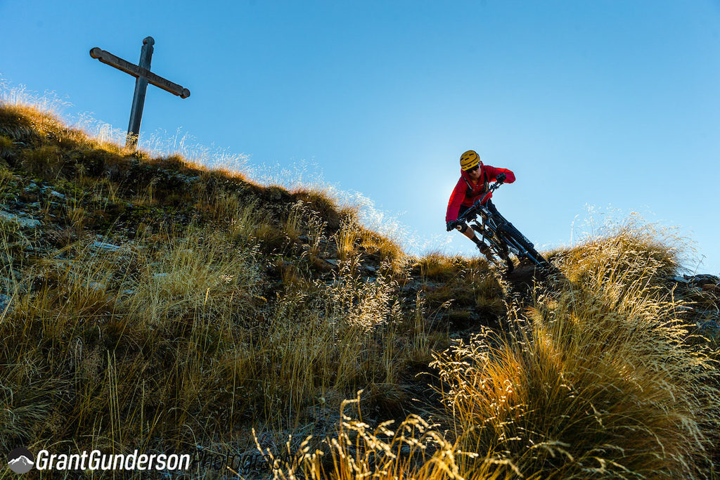 Carston rips down in front of a cross in Verbier. Grant Gunderson photo.