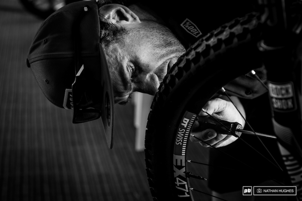 Specialized Gravity republic mechanic, Jack, tuning Loic's brakes. The World Champ is running bladed spokes for the high speed track.
