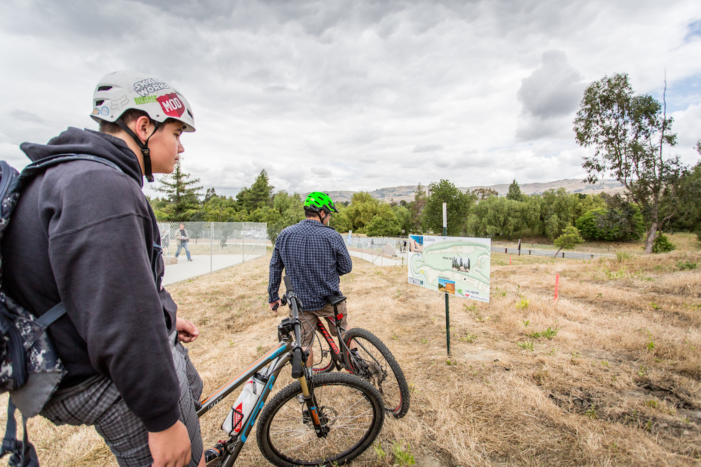 A couple of bike riders look over the plan board for the Slopestyle Course.  The course will feature several wood features including a "Whale Tail" and four wall rides, with berms near 10 feet high according to Justin Beck.