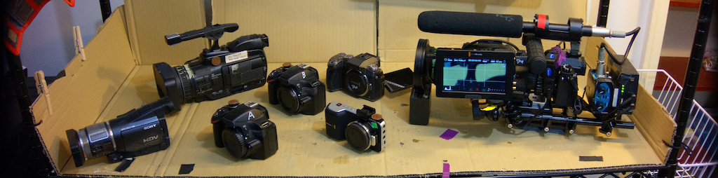 Left to right:
- Sony HDR-HC1 (dead)
- Panasonic HMC40
- Nikon D3200 (2 of them)
- BlackMagic Pocket Camera
- Lumix G7 body
- Lumix G7 in ENG configuration