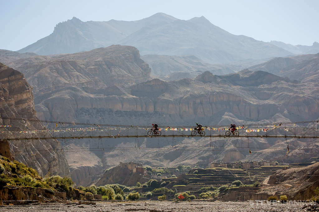 Riding over the suspension bridge in Chhusang in the Upper Mustang region of Nepal