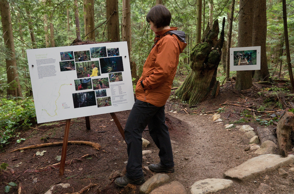 A hiker stops to read one of the informational posters we put along the installation. This is most common location for hikers and runners to first encounter the project, and it's unfortunately at the end. So we included maps to help guide people to the beginning of the project so they can experience the entire thing.