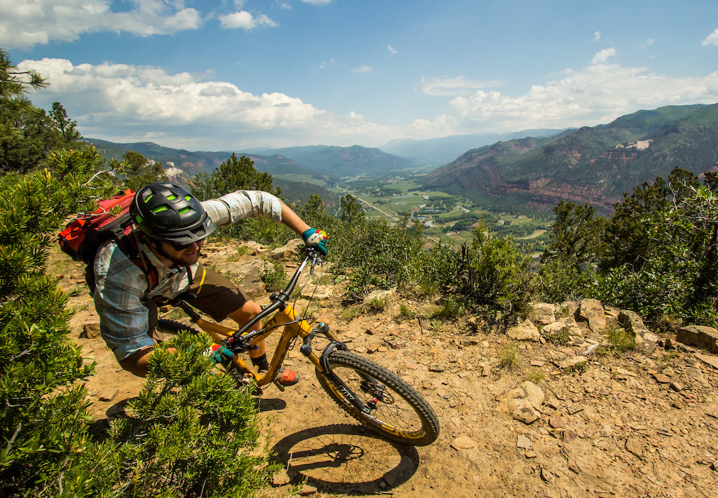 Ben rips around a corner with fantastic views of the Animas River Valley