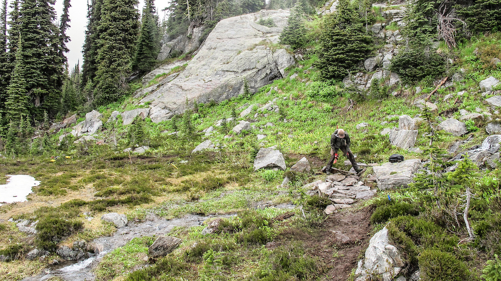 It's a labour intensive process building trails in the alpine but the effort is needed to build sustainable trails.  Marc Reimer laying rocks on the South Caribou Pass trail.