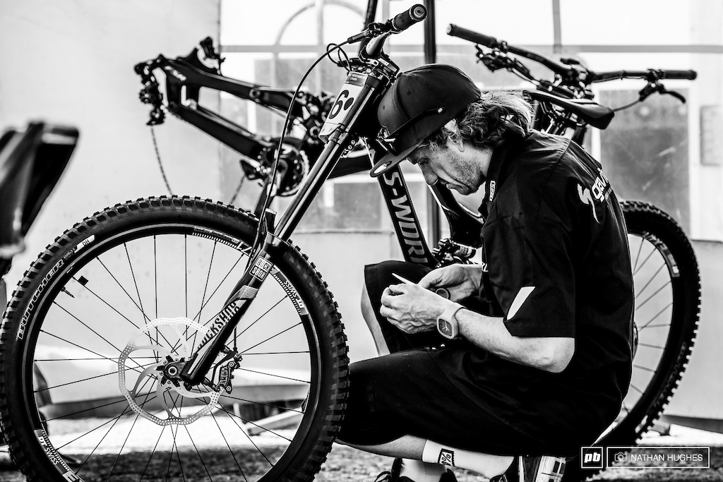 Jack makes the finishing touches to Loic's red hot ride in the Gravity Republic pit.