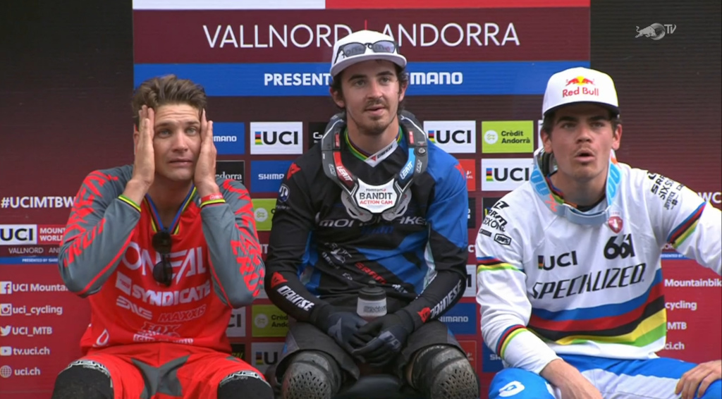Jorba rides into the trees midway through his run and the podium reacts. Greg Minnaar, Danny Hart, and Loic Bruni.