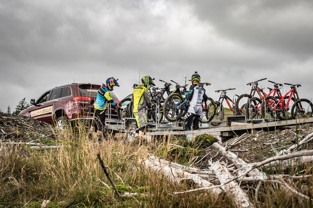 Riders unloading their bikes at the top of the hill.