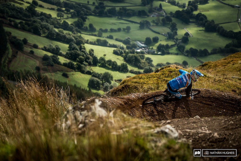 The defending champ, Cunningham, pinning it through the turns high above the valley floor.