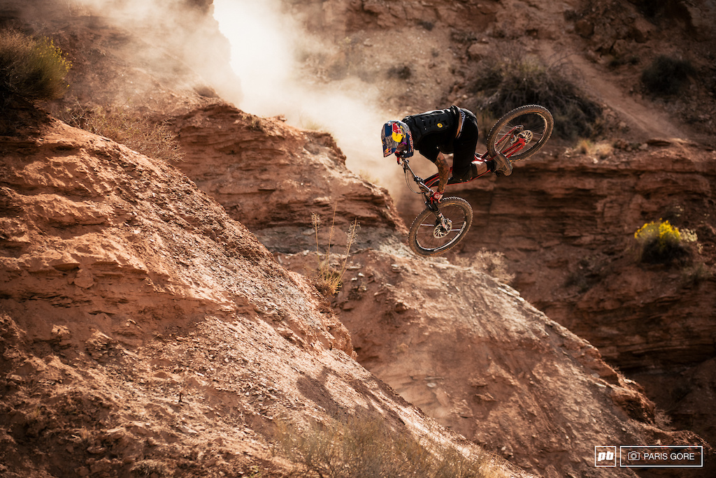 Andreu Lacondeguy spinning halfway down the mountain and into a heavy drop.