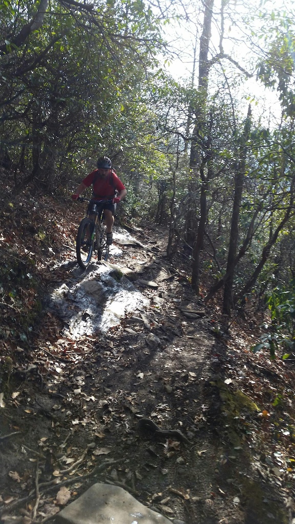 Riding over some wet rock on the side of Laurel, in Pisgah.