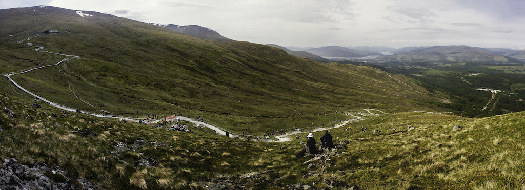 Panorama of the entire view of Fort Bill World Cup Downhill track from the start hut to the finish arena, on to the town, Loch Linnhi and Loch Eil. 

This is also a sequence of Matt walker on track in the leaders jersey for his qualifying run.